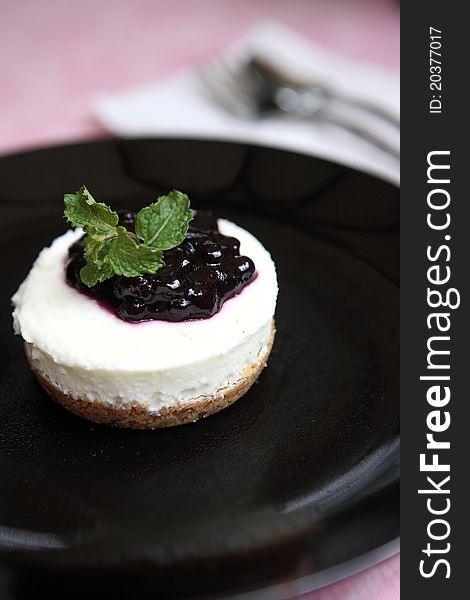 Blueberry cheesecake on black dish