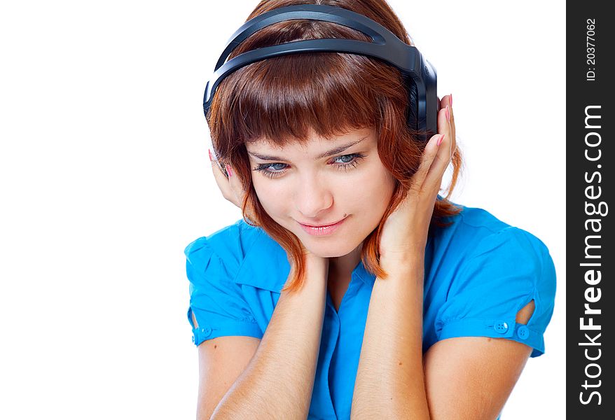 Red-haired teen-girl listen to music in headphones. Isolated on white background