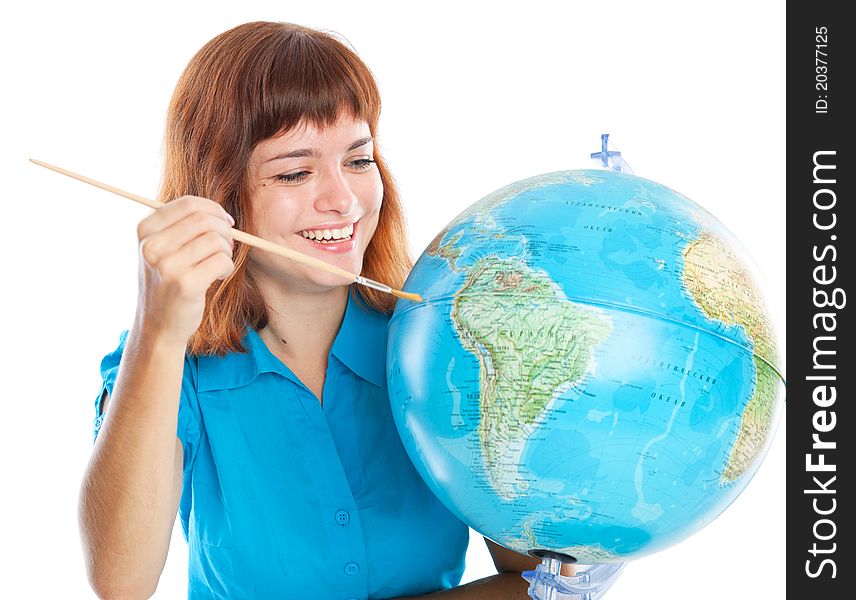Red-haired girl is painting globe. Isolated on white background