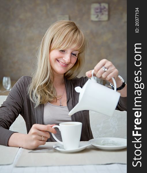 A smiling woman is in cafe