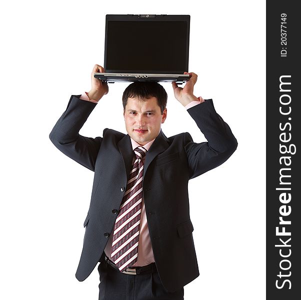 A businessman is holding the laptop above his head. Isolated on a white background