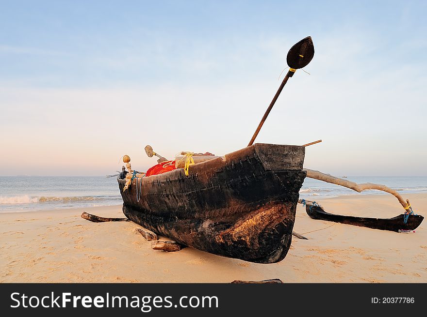 Wooden old fishing boat on the sandy shore. Wooden old fishing boat on the sandy shore