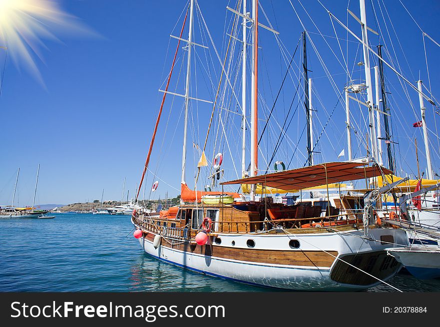 Wooden yacht in blue bay near Bodrum town. Wooden yacht in blue bay near Bodrum town.