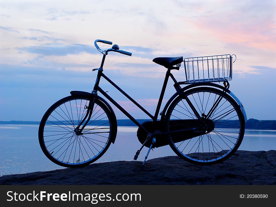 Bicycle on a background of beautiful blue evening sky. Bicycle on a background of beautiful blue evening sky