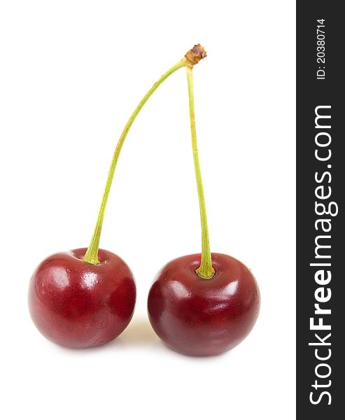 Two cherries on a white background