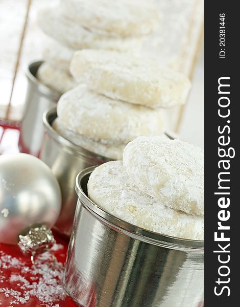 Display of sugared shortbread cookies with white glass ball and fake snow. Display of sugared shortbread cookies with white glass ball and fake snow