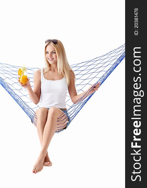 Young attractive girl with a cocktail in a hammock. Young attractive girl with a cocktail in a hammock