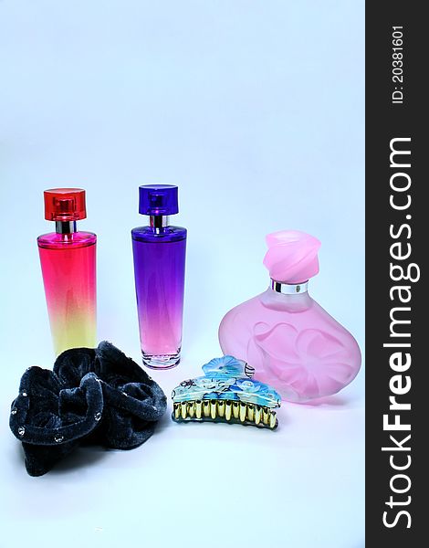 Some perfume and hair accessory with white background