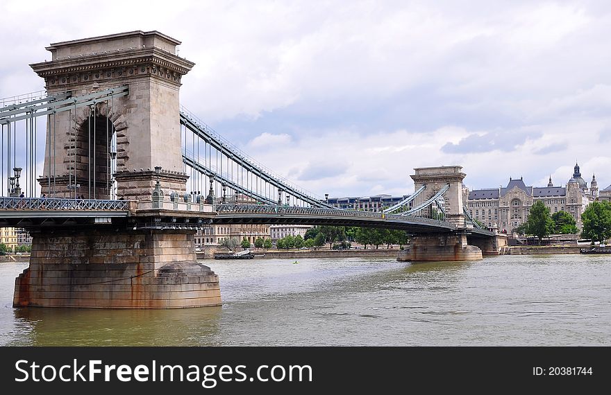 The Széchenyi Chain Bridge (Hungarian: Lánchíd) is a suspension bridge that spans the River Danube between Buda and Pest, the western and eastern sides of Budapest. The Széchenyi Chain Bridge (Hungarian: Lánchíd) is a suspension bridge that spans the River Danube between Buda and Pest, the western and eastern sides of Budapest.