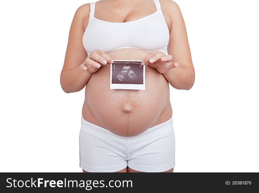 Pregnant woman hold in hand ultrasound investigation picture on a  belly