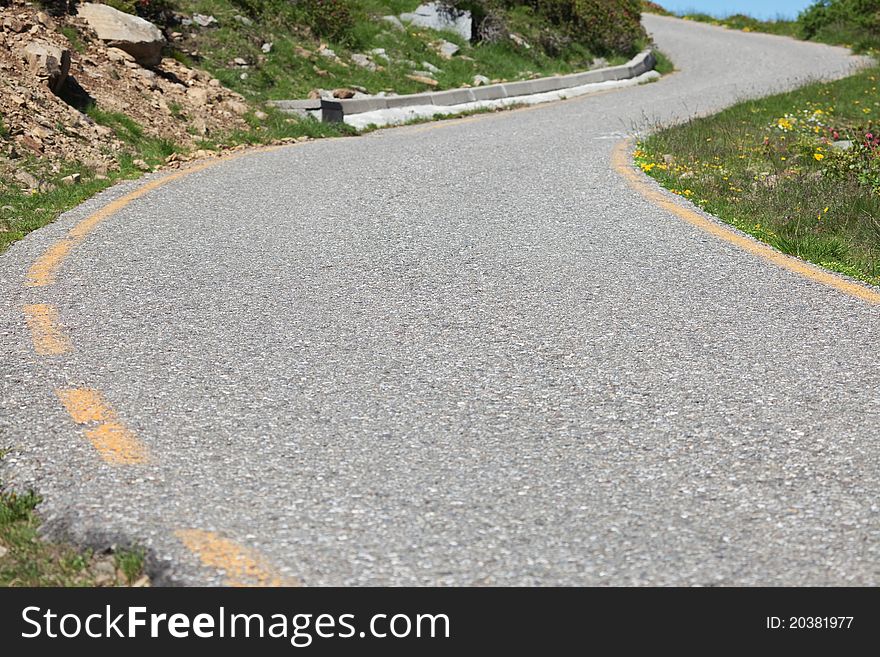 Mountain tarmac road with a only lane and curves. Mountain tarmac road with a only lane and curves