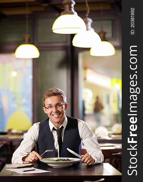 Young smiling man in a restaurant. Young smiling man in a restaurant