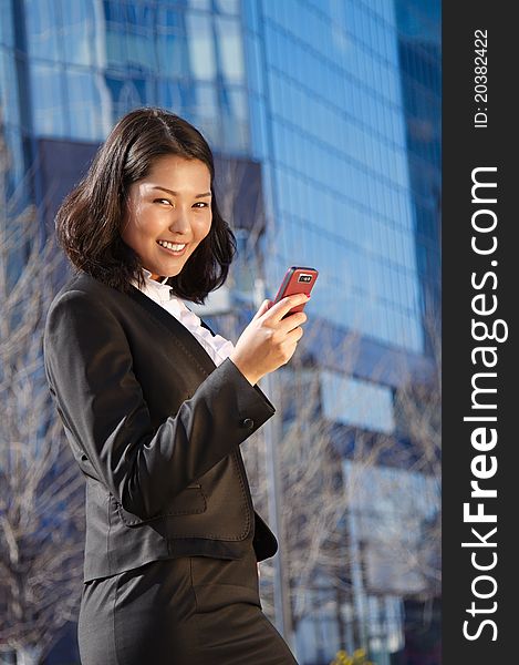 Portrait of a cute asian business woman over business center on back. Portrait of a cute asian business woman over business center on back