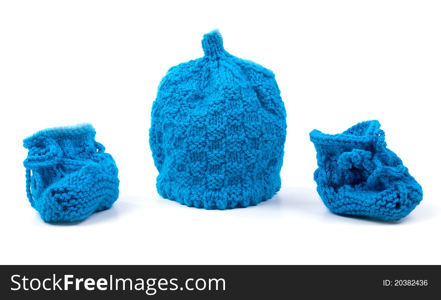 Studio shot of Baby shoes and cap on white background