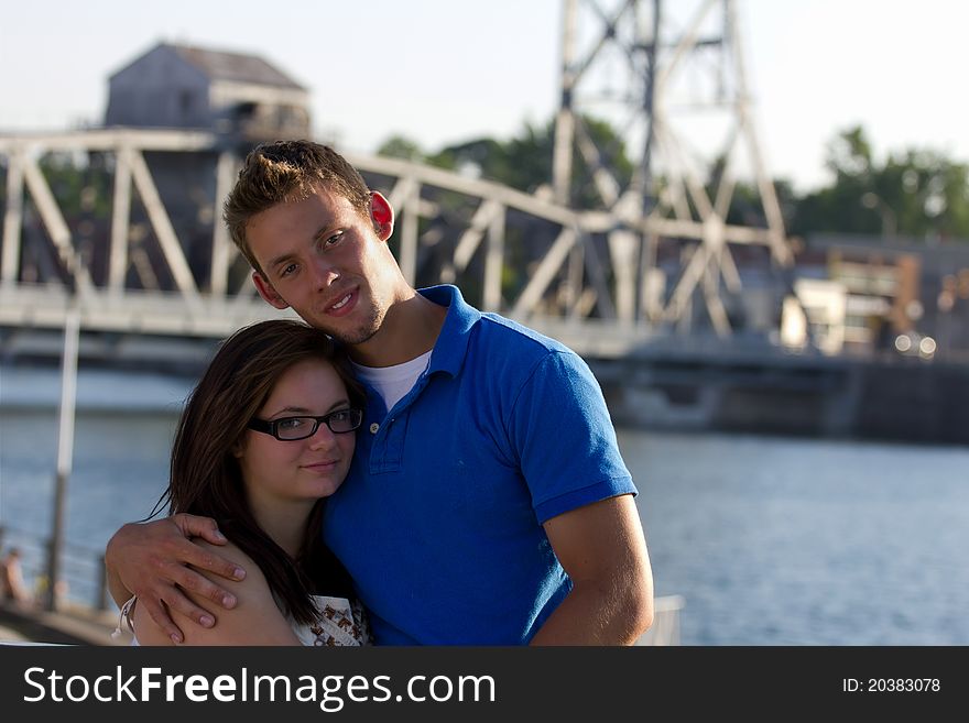 A young couple portrait with bridge in background. A young couple portrait with bridge in background