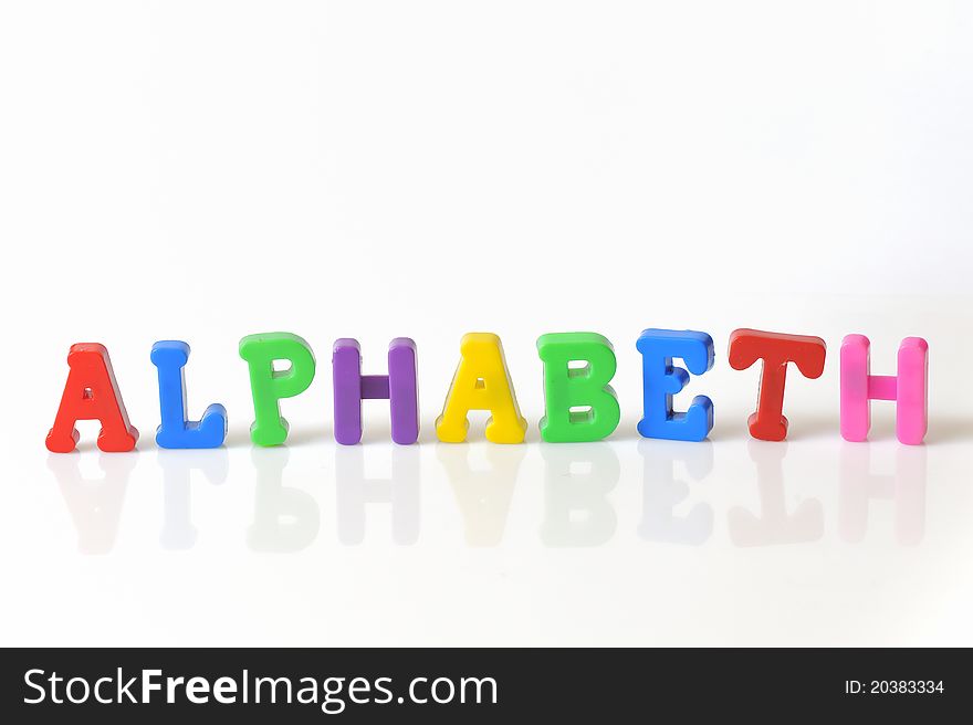 Colorful plastic toy letters isolated on white background