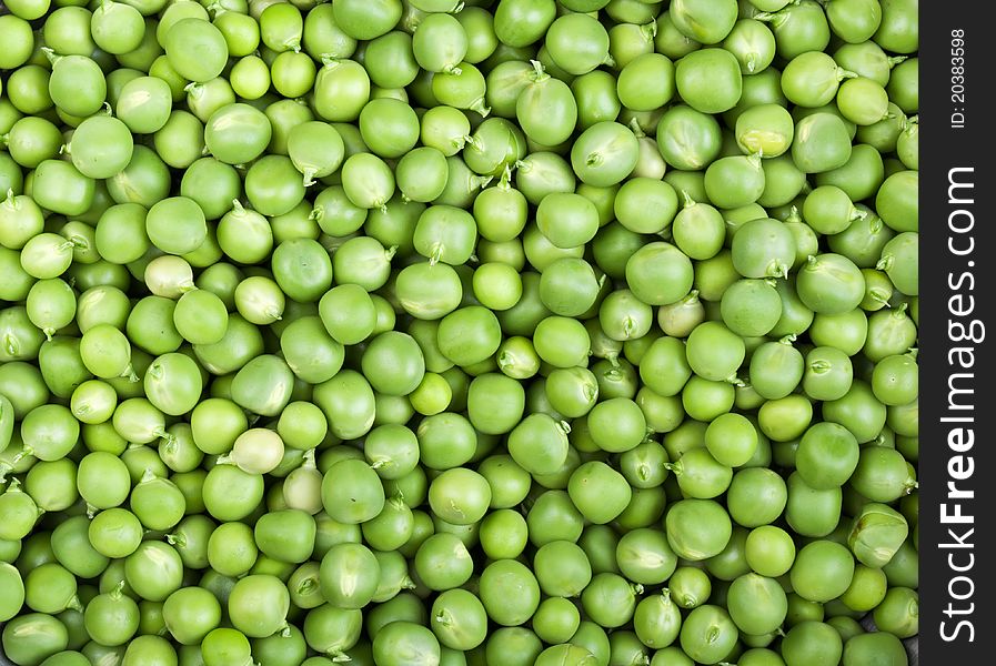 Fresh and green peas on a background