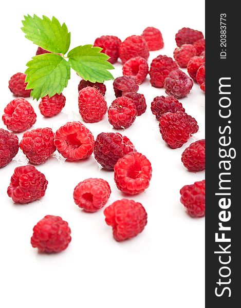 Fresh raspberry and green leaf isolated on a white background