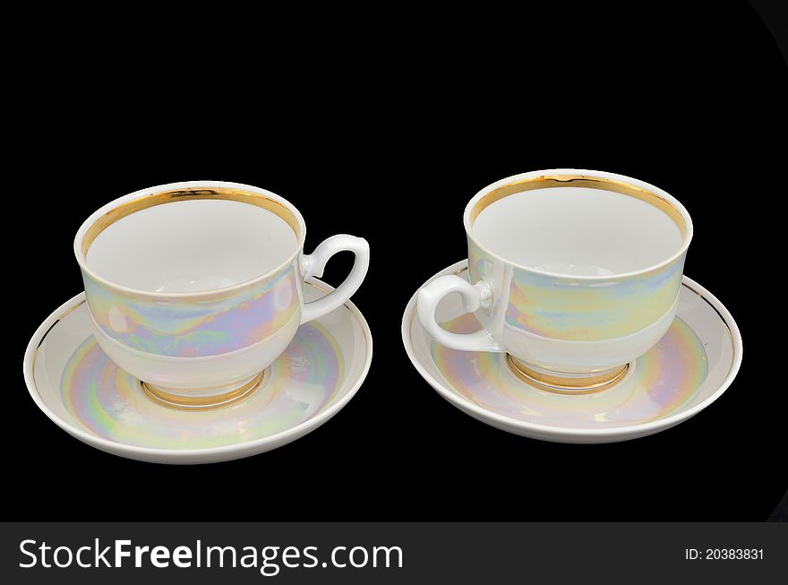 Porcelain cups of coffee on a black background