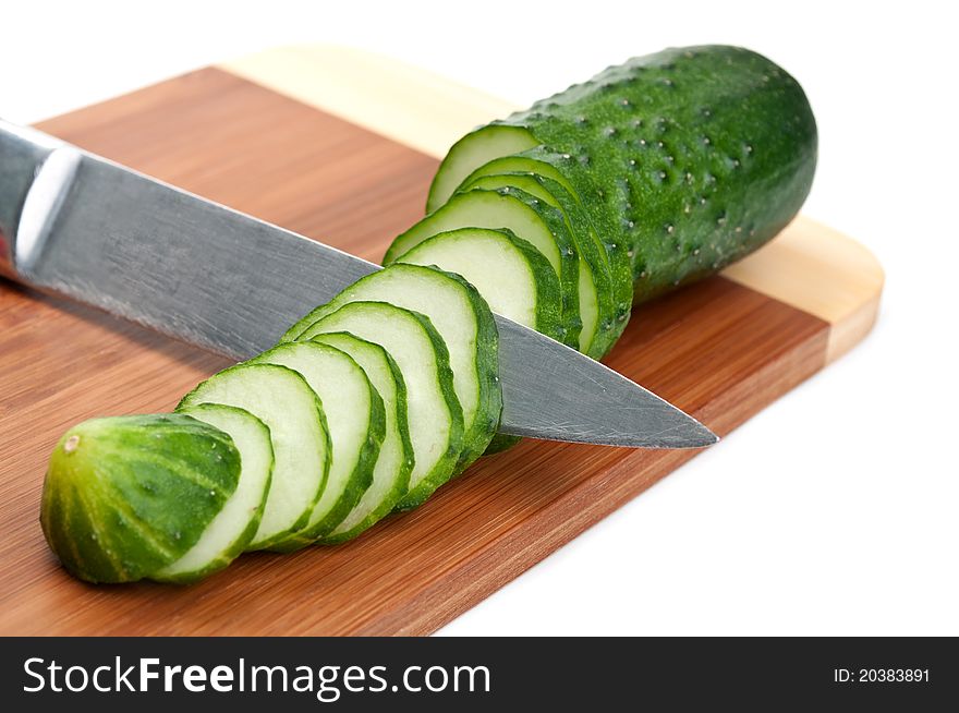 Green cucumber with knife isolated on a white background