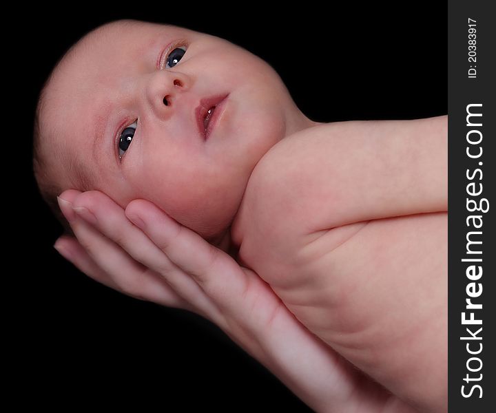 Newborn Held With One Hand. Isolated On Black