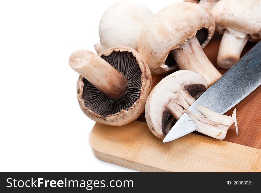Fresh mushrooms and knife isolated on a white background