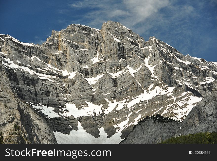 A rugged mountain looks daunting in the summers day. A rugged mountain looks daunting in the summers day.