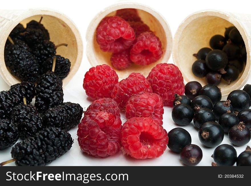 Blueberries and raspberry isolated on a white background