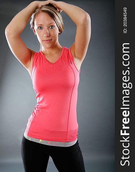 Young woman poses wearing workout outfit. Young woman poses wearing workout outfit.