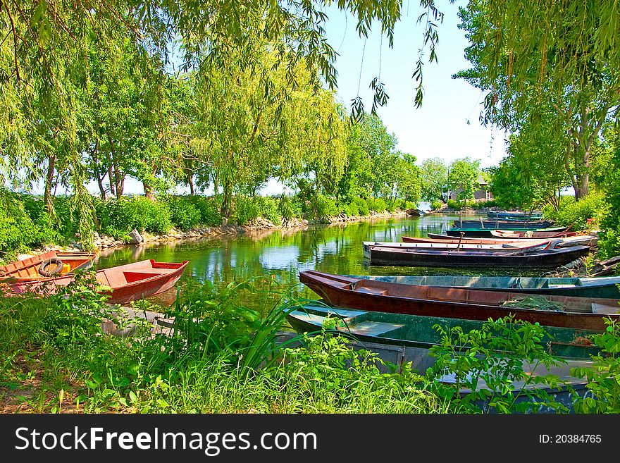 Anchored boats floating on water in small bay