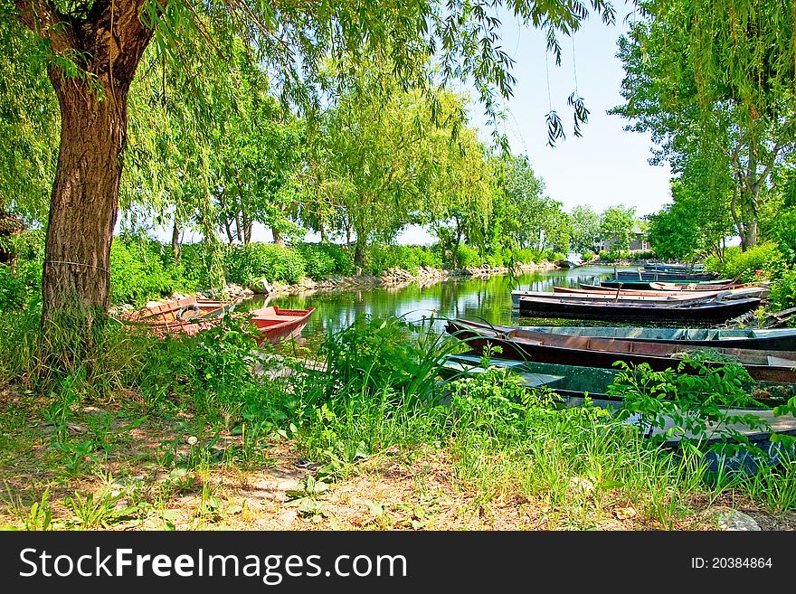 Anchored boats floating on water in small bay