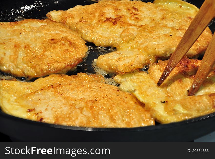 Chicken fillet on the fry pan.