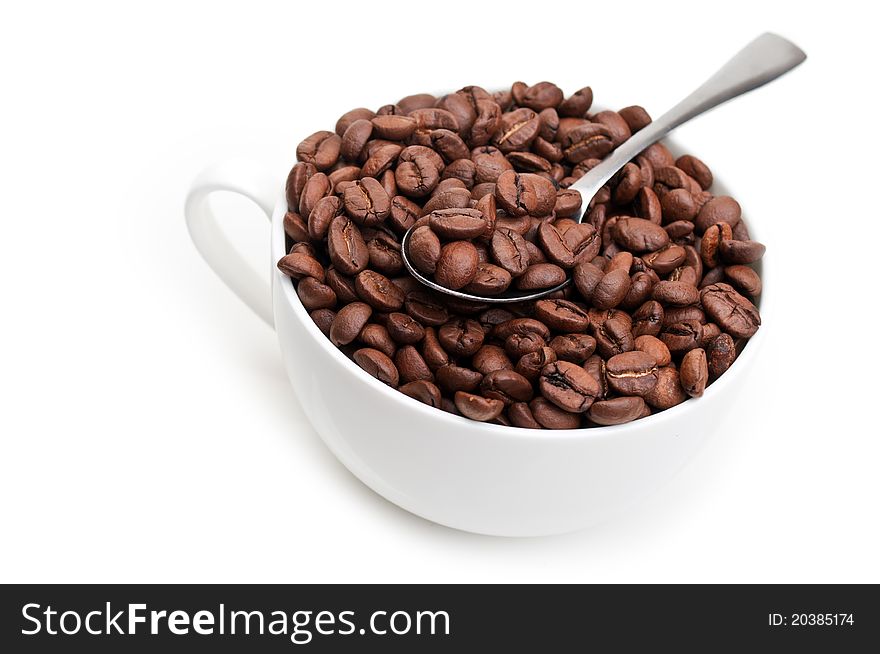 Full cup with coffee beans isolated on a white background