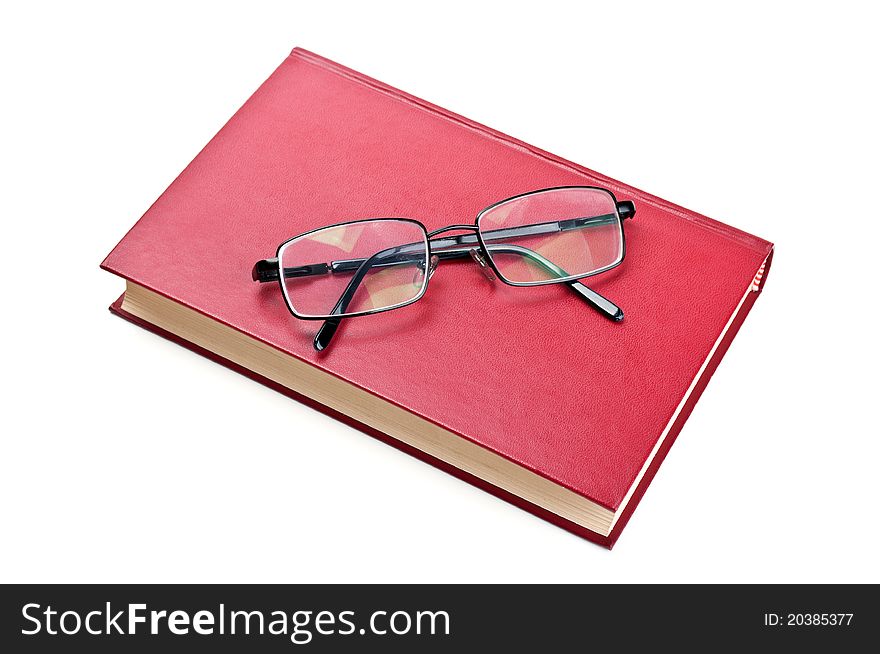 Glasses and red book isolated on a white background