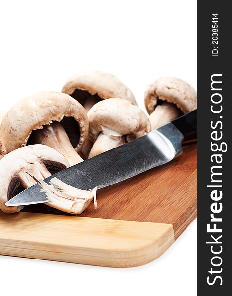 Fresh mushrooms and knife isolated on a white background