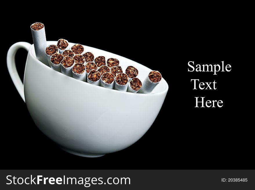 Cup full of cigarettes isolated on a black background