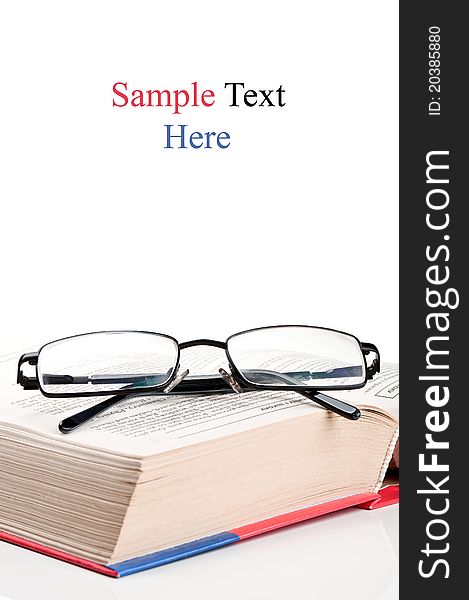 Big encyclopedia book and eyeglasses isolated on a white background