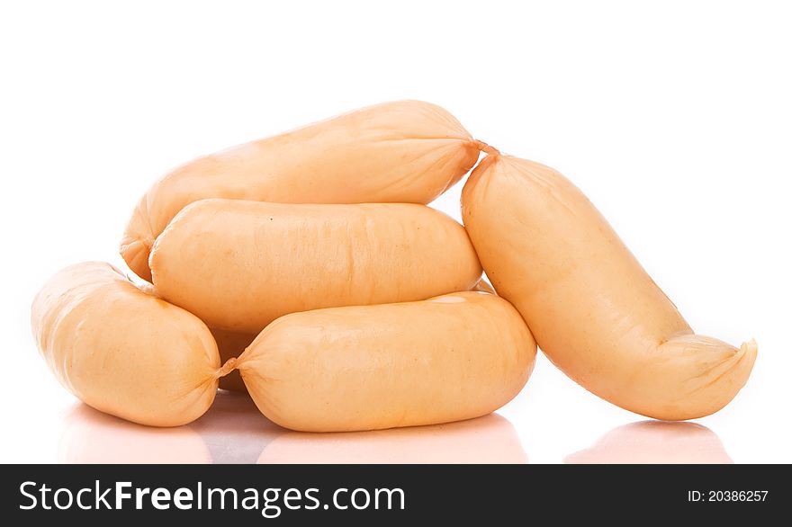 Fresh tasty sausages. Shot over white background