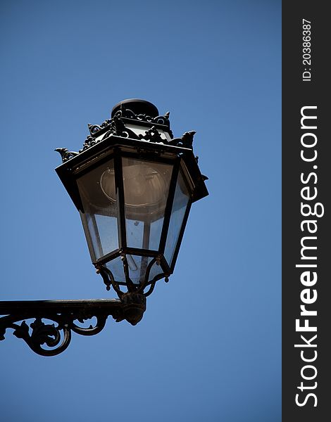 Metal lantern in front of blue sky on the day
