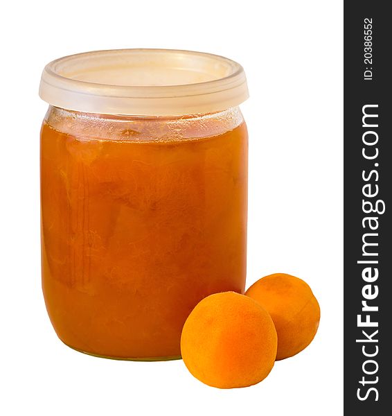 Tasty and healthy apricot jam jar on a white background with two apricots.