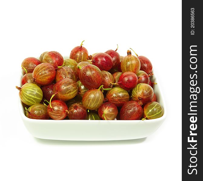 Sunny gooseberry in a plate in white background, closeup