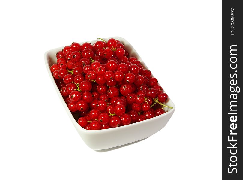 Fresh red currant berry in a plate at white background. Fresh red currant berry in a plate at white background