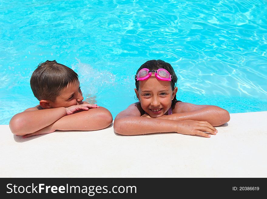 Girl And Boy Relaxing Near  Swimming Pool