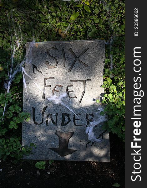 A Tombstone, chiseled 'Six feet under'. A Tombstone, chiseled 'Six feet under'