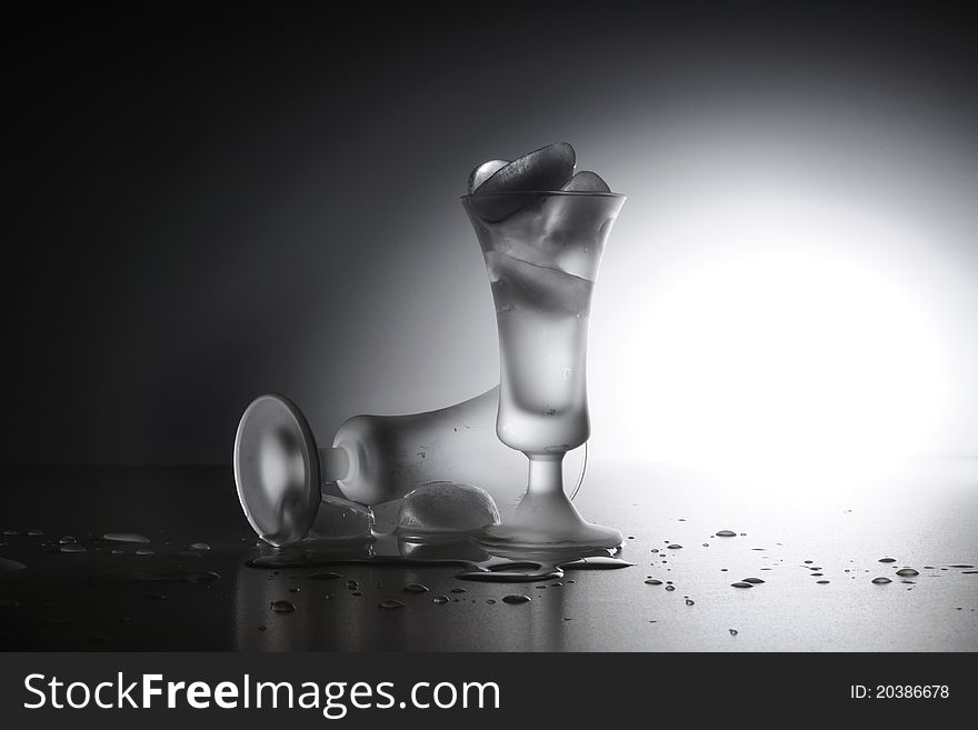 Two Glasses with Ice on a white table. Two Glasses with Ice on a white table