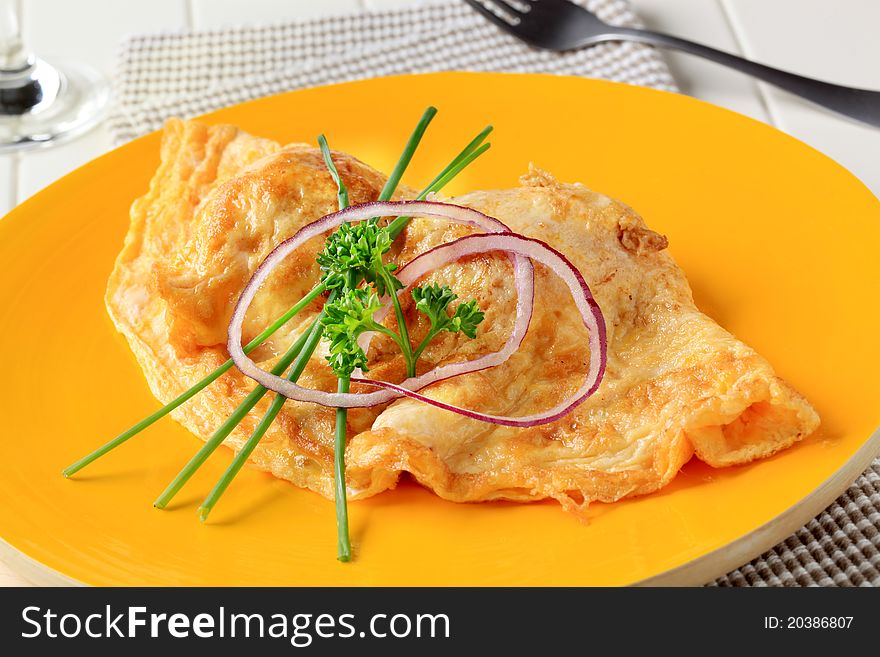 Egg omelet on yellow plate