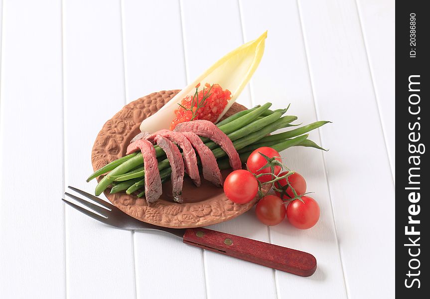 Strips of roast beef and fresh vegetables. Strips of roast beef and fresh vegetables