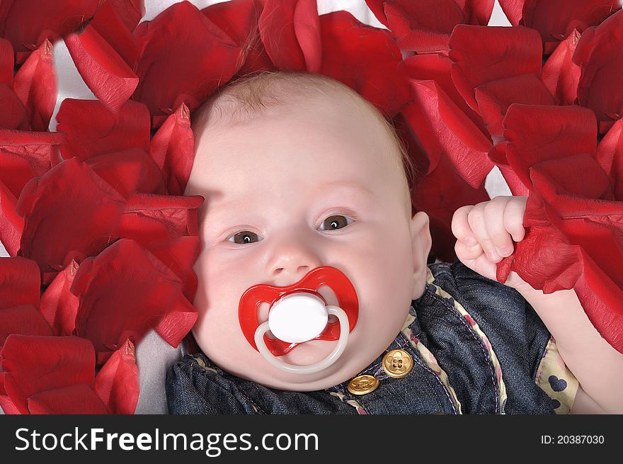 The baby's face with the red dummy