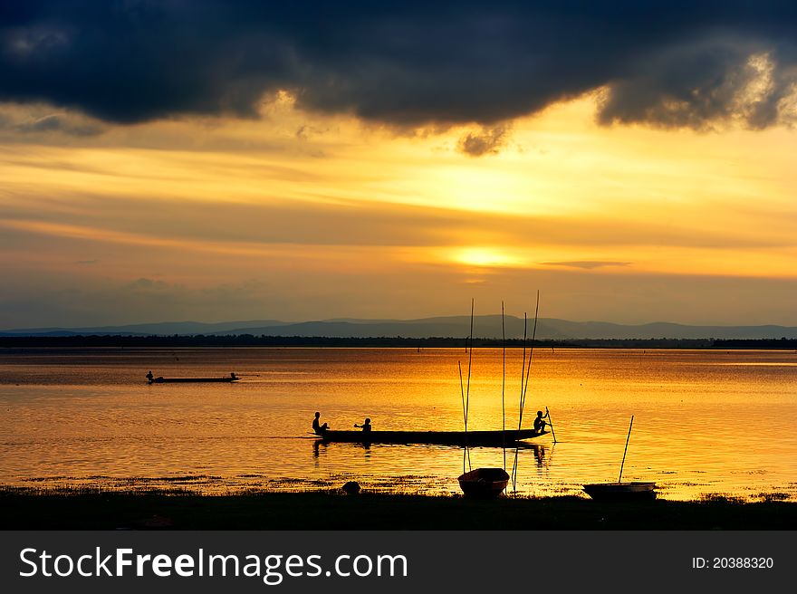 Silhouette of children on wood boat at sunset. Silhouette of children on wood boat at sunset