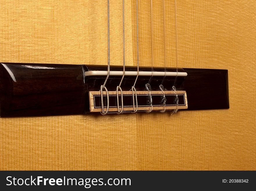 Close up of Spanish classical guitar birdge. Close up of Spanish classical guitar birdge